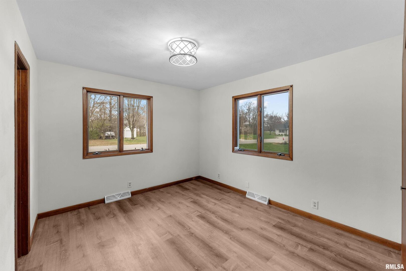 209 Lake View Court Colona, IL 61241 - Photo 13 of 32 wooden floor in an empty room with a window