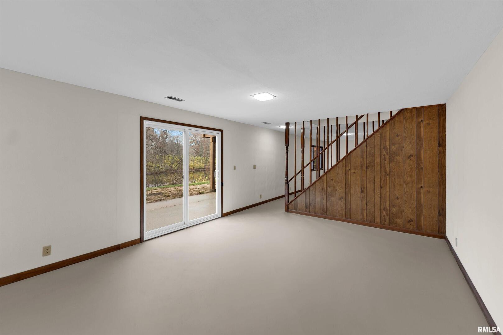 209 Lake View Court Colona, IL 61241 - Photo 22 of 32 a view of an empty room with wooden floor
