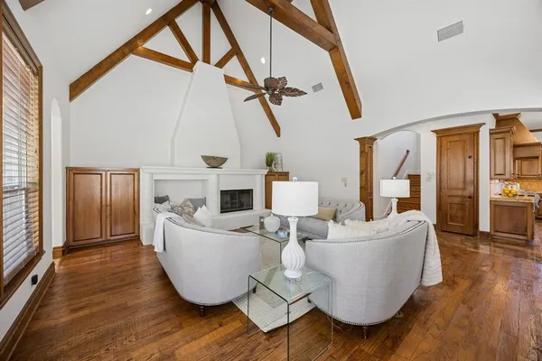 a living room with furniture and a floor to ceiling window
