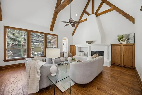 a living room with fireplace furniture and a wooden floor