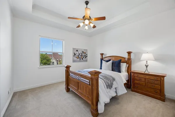 a bedroom with a bed and a chandelier