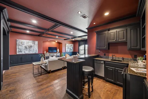 a kitchen with a sink stove and cabinets
