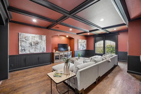 a living room with furniture a large window and a flat screen tv
