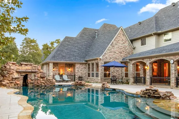 a front view of a house with swimming pool having outdoor seating