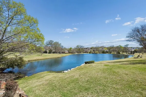 a view of a lake with houses in the back