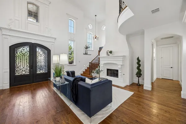 a living room with fireplace furniture and a wooden floor