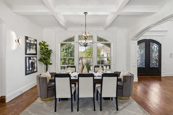 a view of a dining room with furniture wooden floor and chandelier
