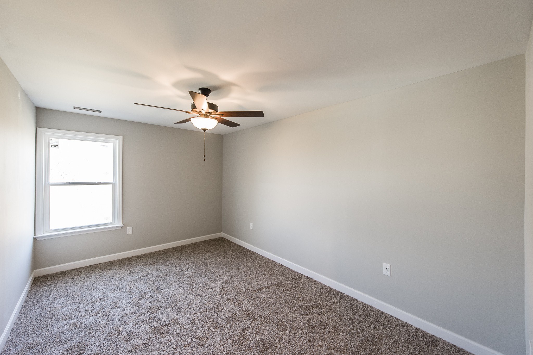 815 West Spring Street Lebanon, TN 37087 - Photo 22 of 32 an empty room with a window and a ceiling fan