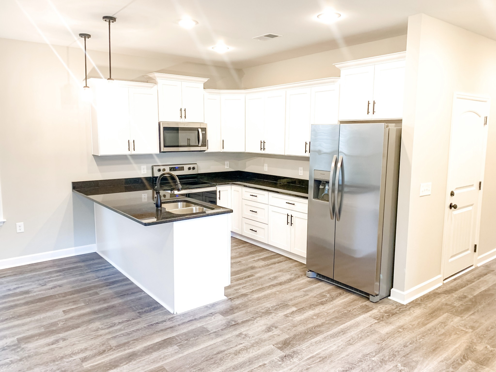 815 West Spring Street Lebanon, TN 37087 - Photo 4 of 32 a kitchen with a sink refrigerator and microwave
