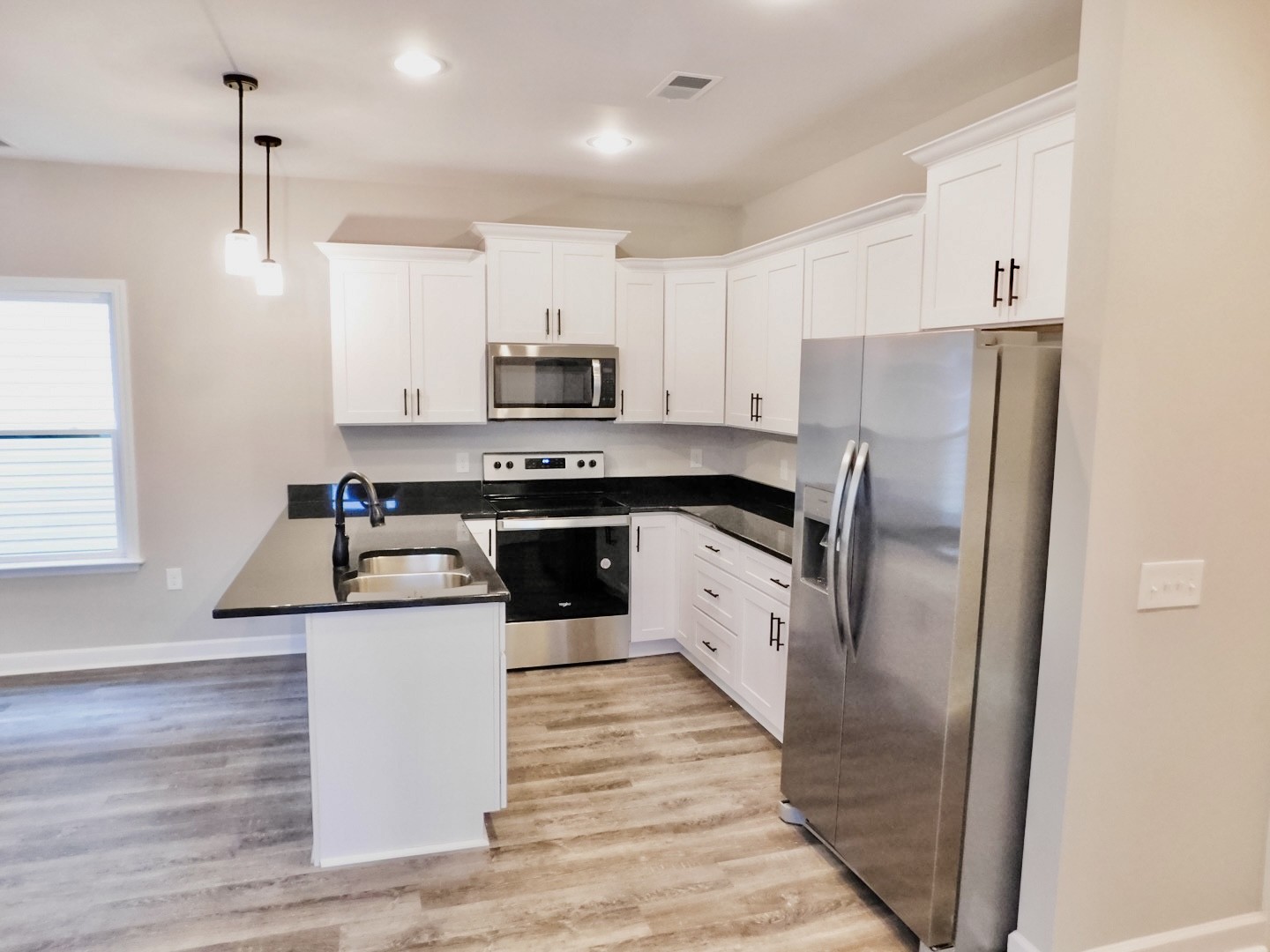 815 West Spring Street Lebanon, TN 37087 - Photo 5 of 32 a kitchen with stainless steel appliances a refrigerator sink and microwave