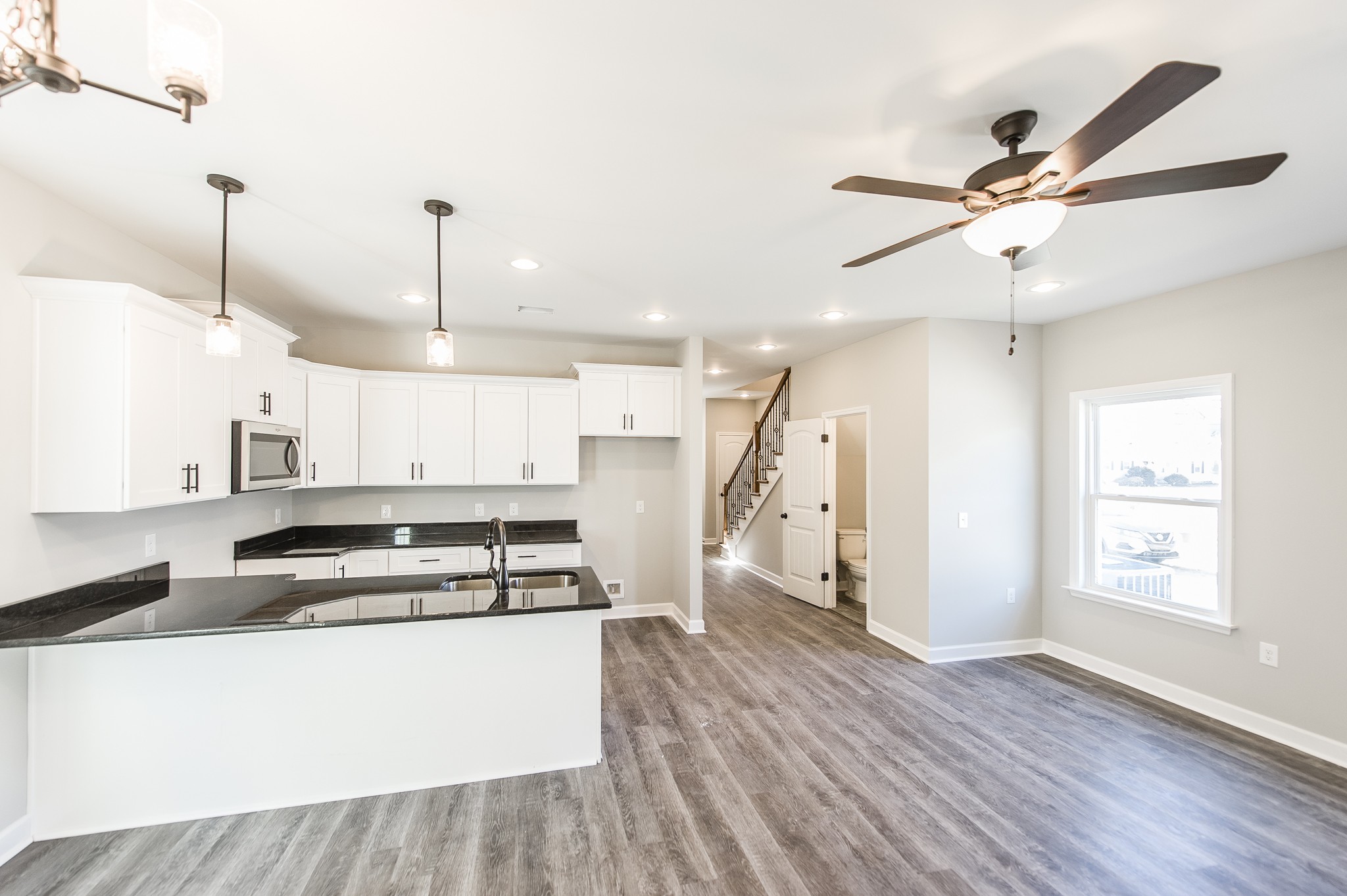 815 West Spring Street Lebanon, TN 37087 - Photo 8 of 32 a open kitchen with stainless steel appliances granite countertop a stove a refrigerator a sink a center island with wooden floor and cabinets