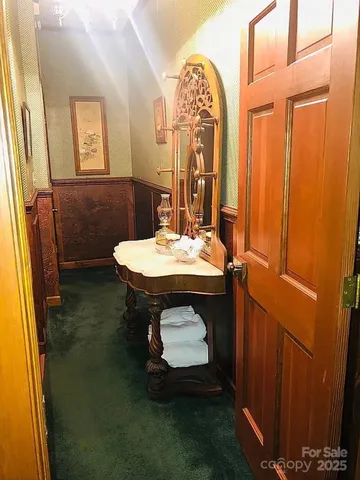 an empty room with wooden floor and cabinet