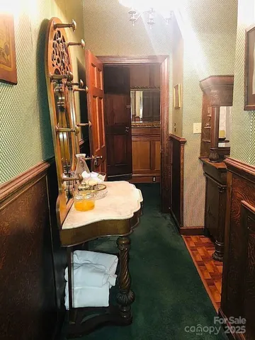 a kitchen with stainless steel appliances a table chairs and a refrigerator