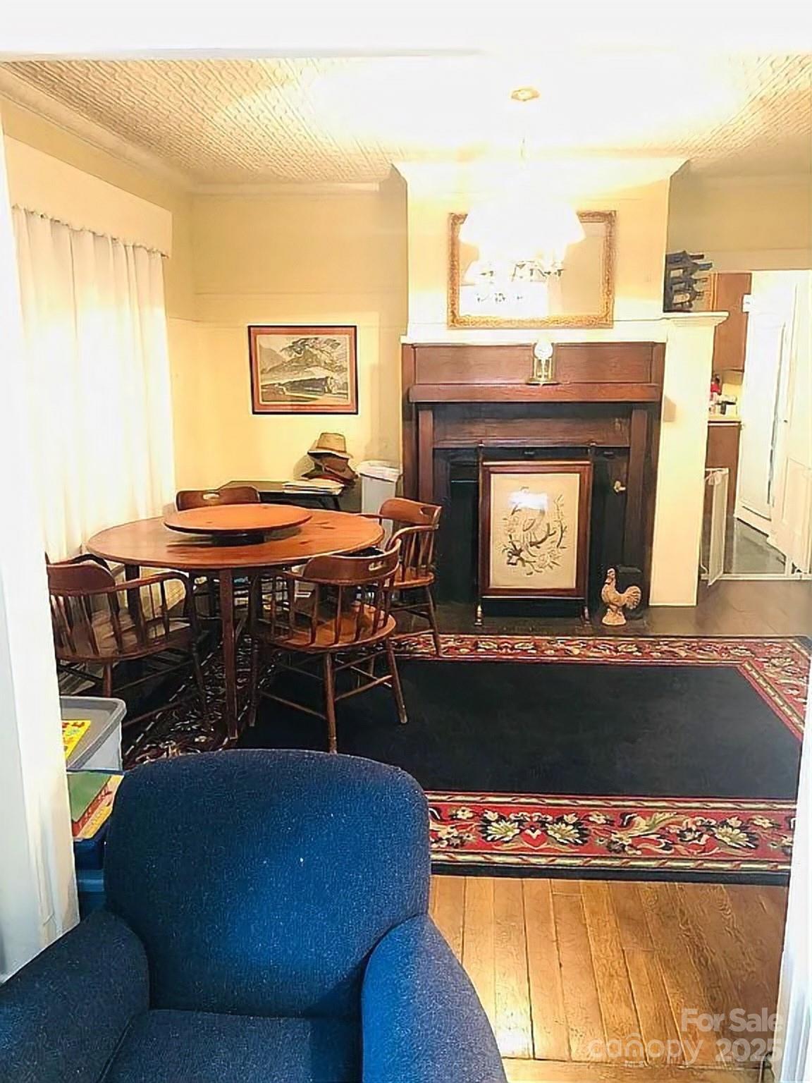 115 South Pearl Street Troy, NC 27371 - Photo 35 of 48 a living room with furniture a fireplace and a table