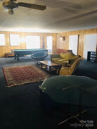a view of a hallway with wooden floor and front door