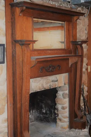 a living room with fireplace furniture and a fireplace