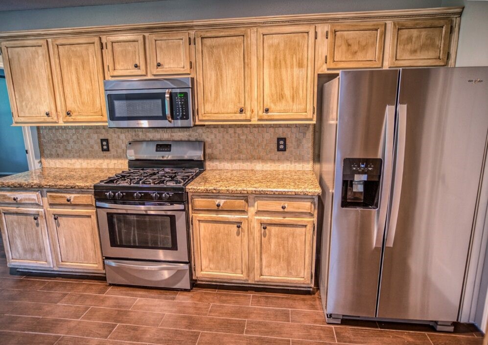 308 County Road 893B Angleton, TX 77515 - Photo 21 of 41 a kitchen with stainless steel appliances granite countertop a refrigerator stove and cabinets