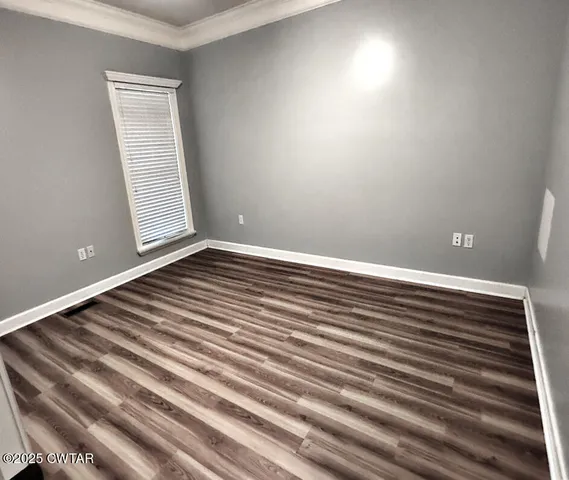 a view of a room with wooden floor
