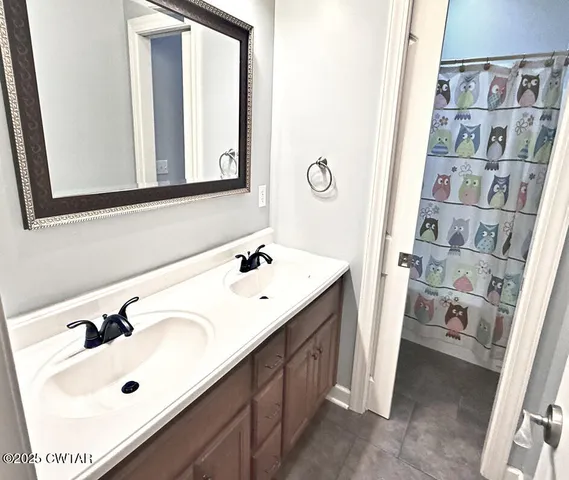 a bathroom with a sink vanity and mirror