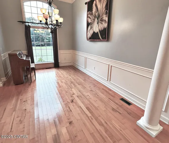 a view of a room with wooden floor and staircase