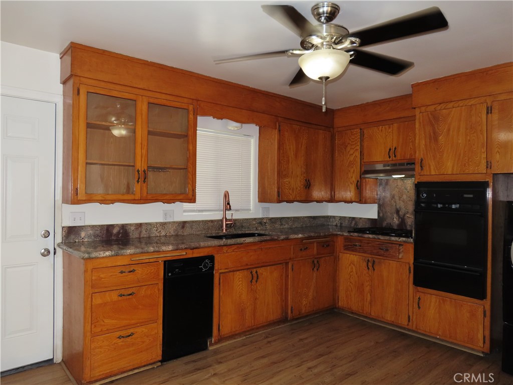 4041 MacArthur Road Riverside, CA 92503 - Photo 7 of 13 a kitchen with granite countertop appliances cabinets and a sink