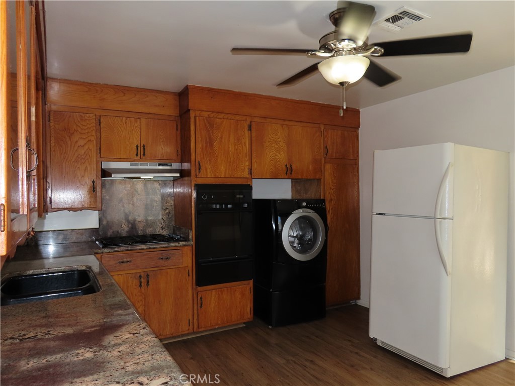 4041 MacArthur Road Riverside, CA 92503 - Photo 8 of 13 a kitchen with a stove and a refrigerator