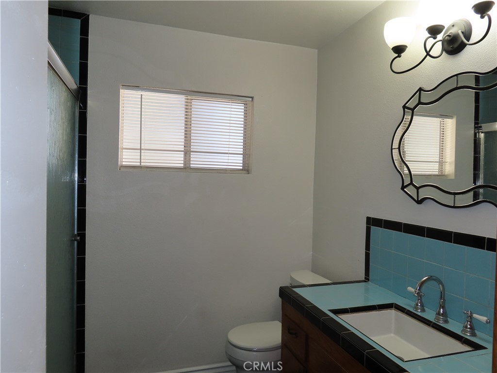 4041 MacArthur Road Riverside, CA 92503 - Photo 9 of 13 a bathroom with a sink a toilet and mirror