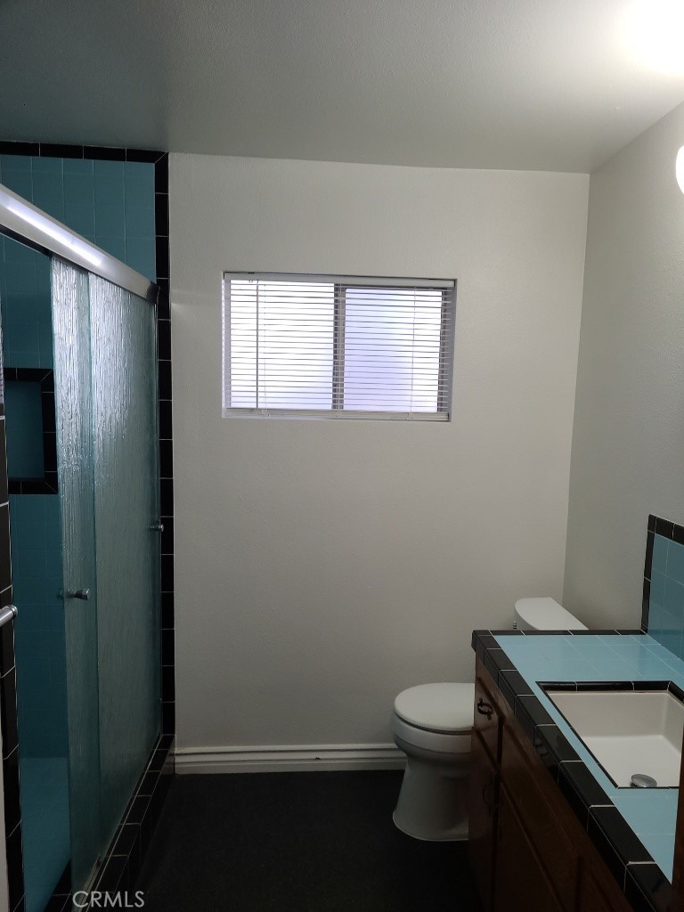 4041 MacArthur Road Riverside, CA 92503 - Photo 10 of 11 a bathroom with a toilet a sink and a window