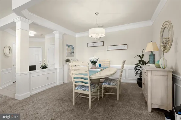 a dining room with furniture and a chandelier