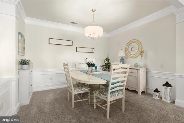 a living room with furniture a rug and a chandelier
