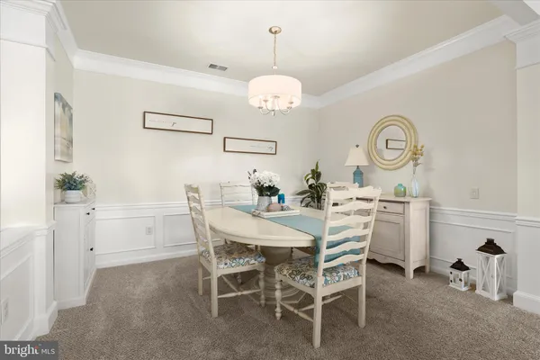 a living room with furniture a rug and a chandelier