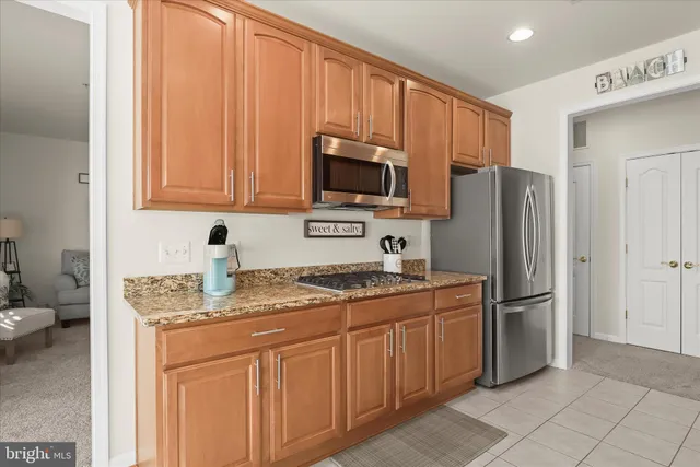 a kitchen with stainless steel appliances granite countertop a stove sink and cabinets
