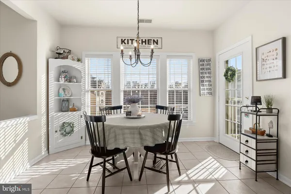 a view of a dining room with furniture and a chandelier