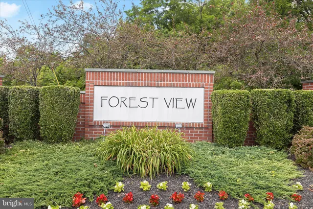 a sign that is sitting in front of flowers