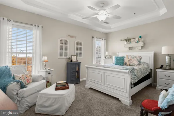 a spacious bedroom with a bed and a chandelier