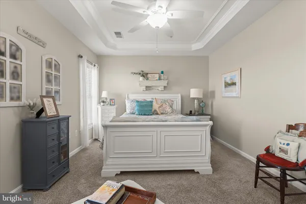 a bedroom with furniture and a large window