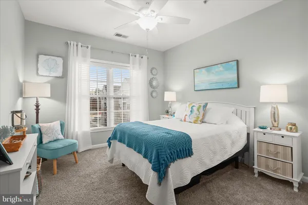 a spacious bedroom with a bed and a window