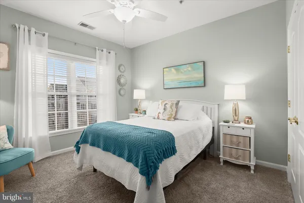 a spacious bedroom with a bed and a window