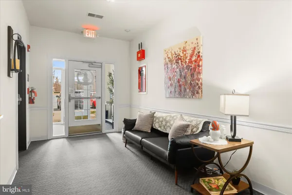 a living room with furniture and a lamp