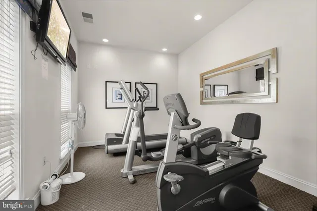 a view of a dining room with furniture and a chandelier