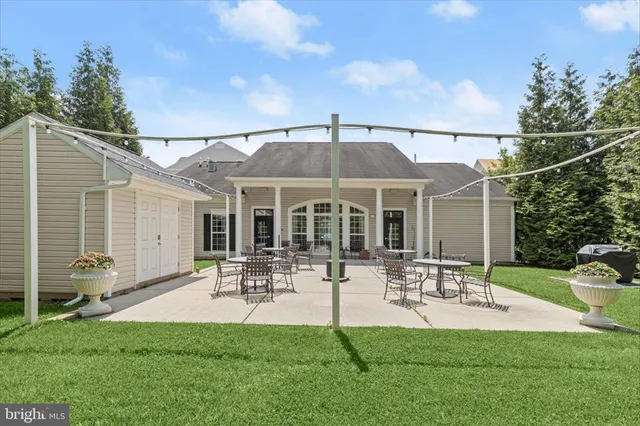 a view of a patio with a dining table and chairs with garden view