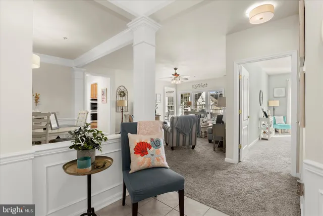 a kitchen with a dining table chairs and white cabinets