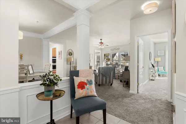 a kitchen with a dining table chairs and white cabinets