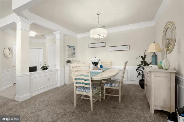 a dining room with furniture and a chandelier