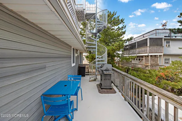a kitchen with white cabinets and refrigerator