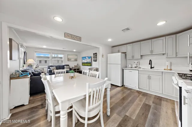a living room with furniture a couch and wooden floor