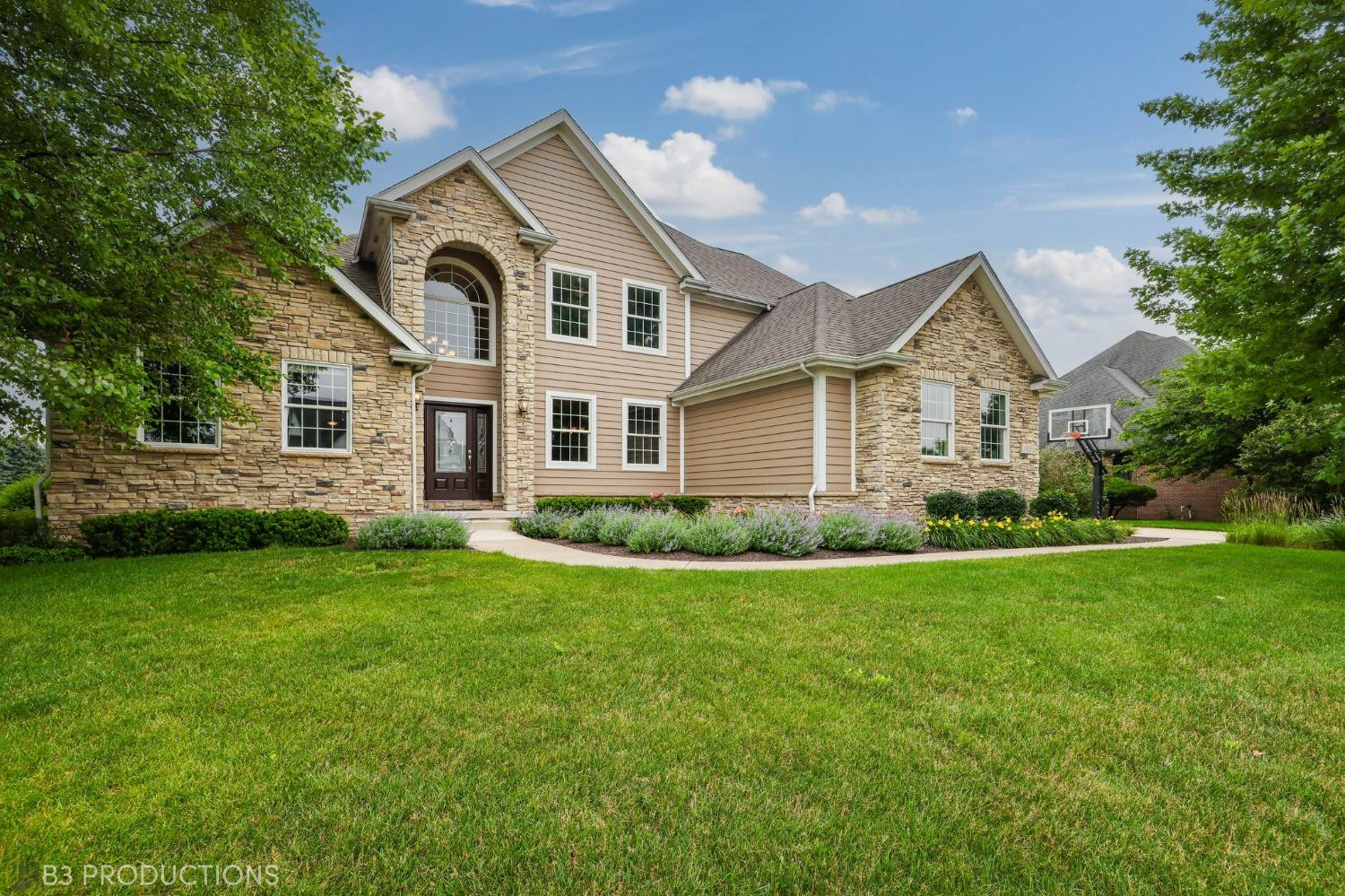 a front view of a house with a garden