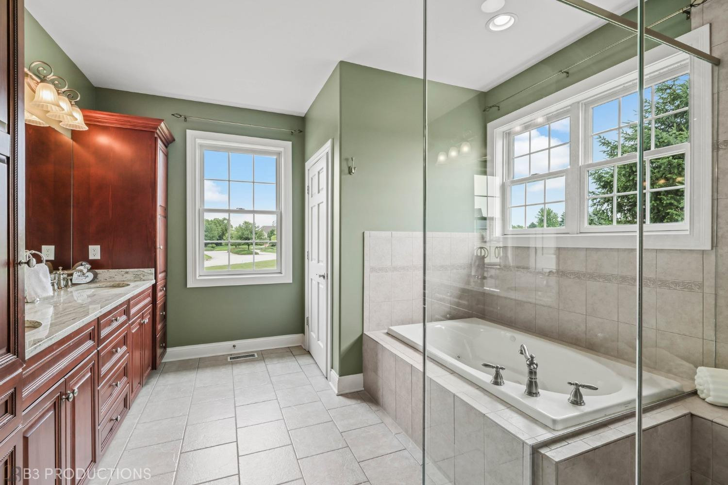 1825 Bramble Trace Chesterton, IN 46304 - Photo 15 of 30 a bathroom with a tub sink shower and mirror