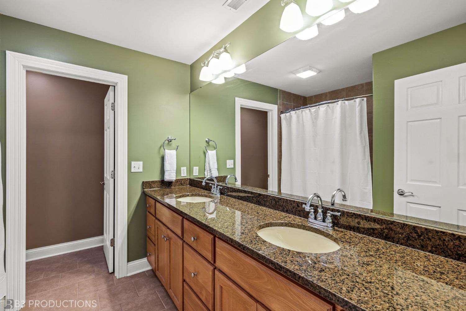 1825 Bramble Trace Chesterton, IN 46304 - Photo 21 of 30 a bathroom with a granite countertop double vanity sink and a mirror