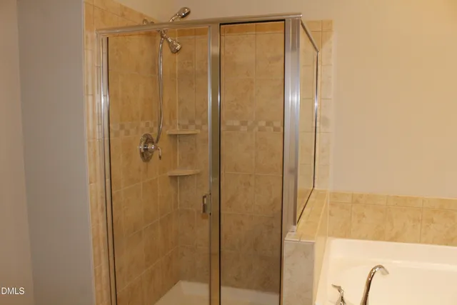 a bathroom with a shower and a tub